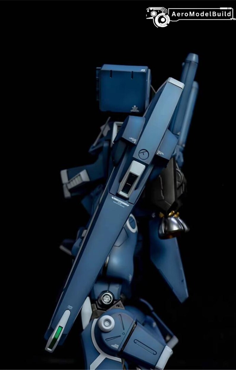 May include: AeroModelBuild logo on a dark background. The image features a detailed, blue model of a futuristic robot or mech. The model has angular panels, metallic accents, and intricate mechanical details.