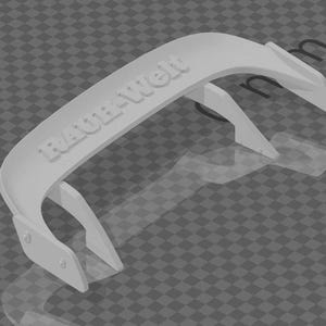 May include: A light gray automotive spoiler with the text "RAUHWELT" embossed on the top. The spoiler has a curved design with two supporting legs and is set against a checkered background.