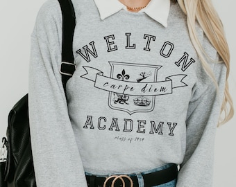 May include: Gray sweatshirt with a black print of a crest that says "Welton Academy" and "carpe diem" with a black belt with a gold double ring buckle.