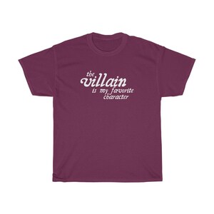 May include: Burgundy t-shirt with white text that reads "the villain is my favorite character"