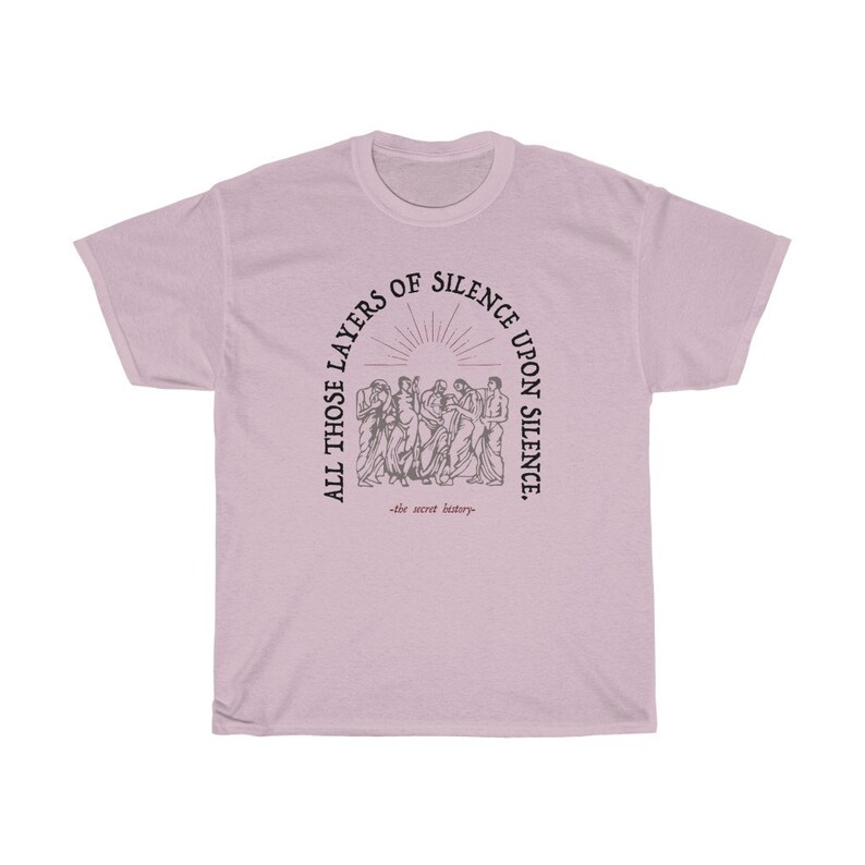 May include: A light pink t-shirt with a black graphic print of a group of people standing in a circle. The text around the circle reads "All those layers of silence upon silence." The text below the circle reads "the secret history."
