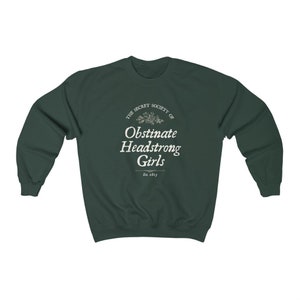 May include: A dark green sweatshirt with a white graphic print that reads "The Secret Society of Obstinate Headstrong Girls Est. 1813".