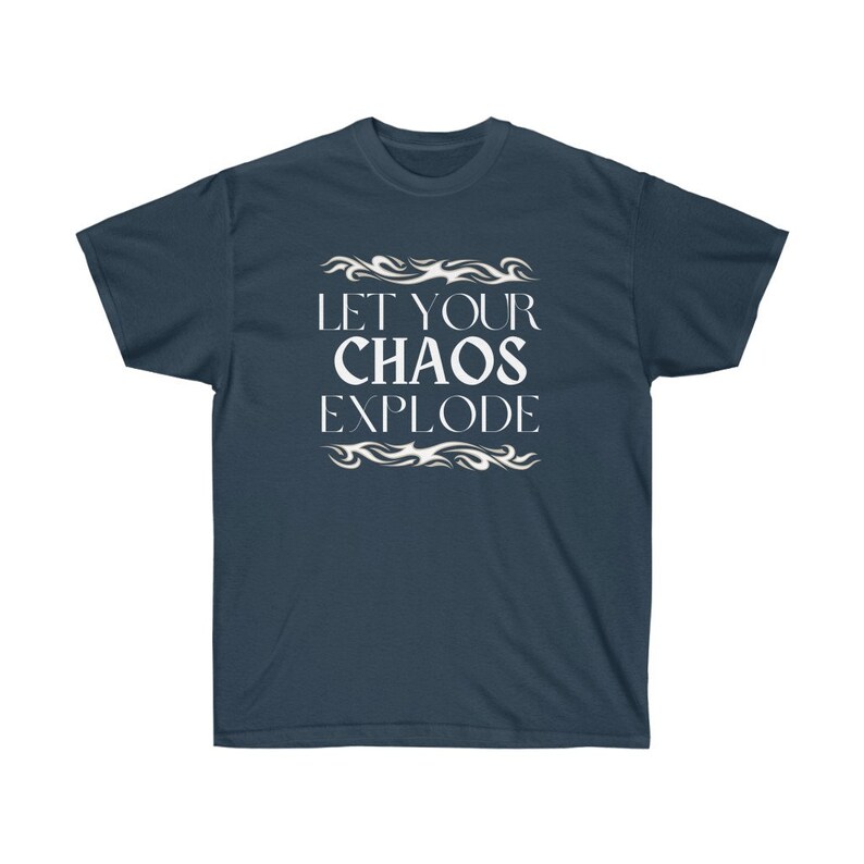 May include: Dark blue t-shirt featuring the white text "LET YOUR CHAOS EXPLODE", framed by flame-like patterns. The shirt has a crew neck and is a solid colour.