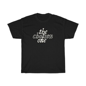 May include: Black t-shirt with white text that reads "the chosen one" in a stylized font.