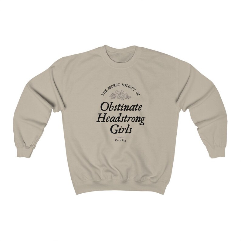 May include: A beige sweatshirt with a black graphic print that reads "The Secret Society of Obstinate Headstrong Girls Est. 1813".