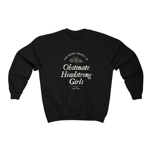 May include: Black sweatshirt with a white graphic print that reads "The Secret Society of Obstinate Headstrong Girls Est. 1913".