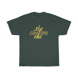 May include: A dark green t-shirt with the text "the chosen one" in yellow.