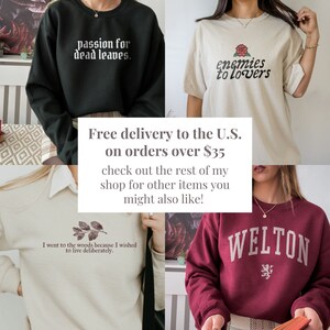 May include: Four different sweatshirts with various designs and text. The sweatshirts are black, white, maroon, and beige. The text on the sweatshirts includes "passion for dead leaves", "enemies to lovers", "I went to the woods because I wished to live deliberately", and "WELTON".