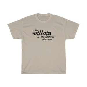 May include: A beige t-shirt with the text "the villain is my favorite character" printed in black.