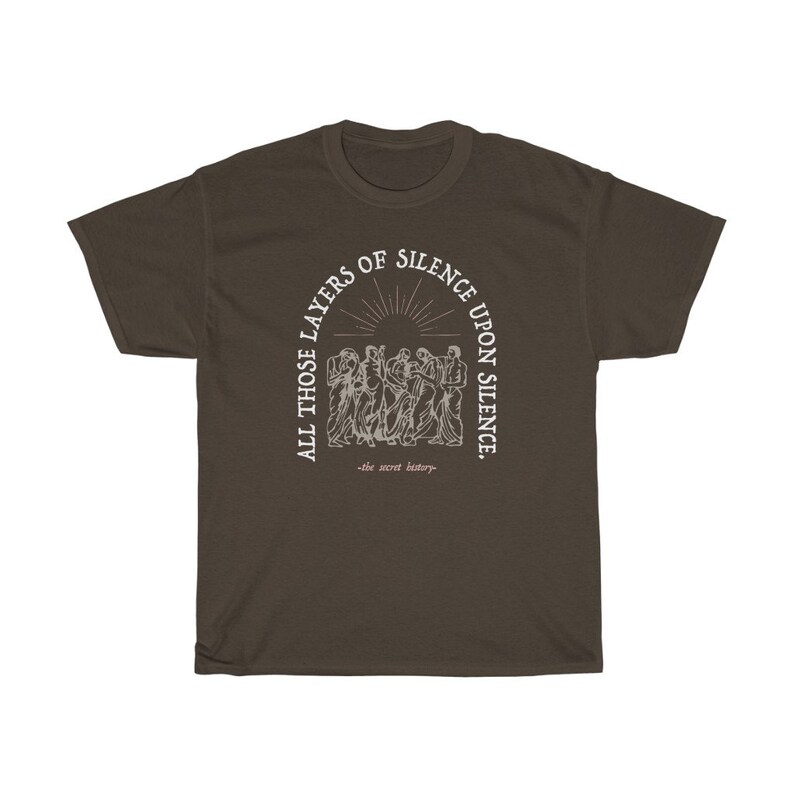 May include: A brown t-shirt with a white graphic print of a group of people standing in a circle. The text reads "All those layers of silence upon silence -the secret history-."