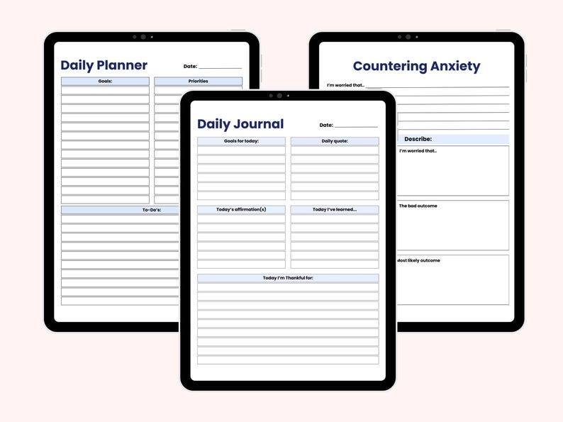 May include: Three black tablets displaying digital planner pages. The tablets show the titles "Daily Planner", "Daily Journal", and "Countering Anxiety". Each tablet has a white background with blue text and lines for writing.