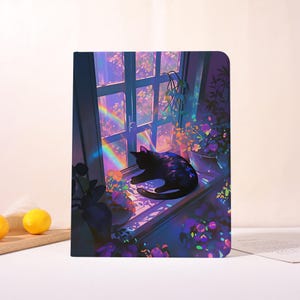 May include: Notebook featuring a digital illustration of a black cat resting on a windowsill. The scene includes a rainbow, flowers, and a window with a view of a garden. The color palette is dominated by blues, purples, and greens.