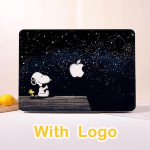 May include: Black laptop case featuring Snoopy and Woodstock looking at a glowing Apple logo against a starry night sky. The case has the words "With Logo" in yellow.