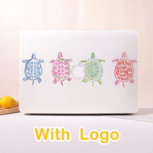 May include: A white laptop with four colorful turtle designs. The turtles are in blue, pink, green, and orange, with watercolor-style details. The text "With Logo" is displayed in yellow at the bottom.