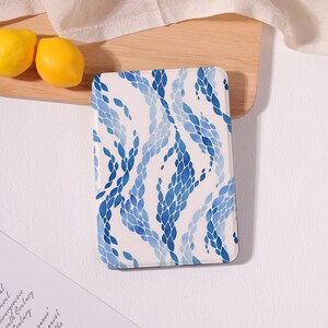 May include: A rectangular e-reader case featuring a white background with a repeating pattern of blue watercolor-style leaf or petal shapes arranged in vertical, flowing, wave-like columns across the entire surface of the protective cover.