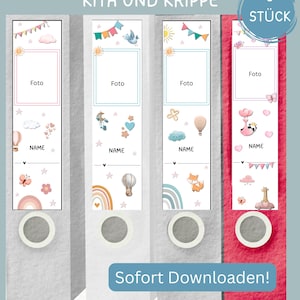 May include: A set of nine binder spines with colorful illustrations and the words "ORDNERRÜCKEN KITA UND KRIPPE" and "Sofort Downloaden!". Each spine has a space for a photo and the word "NAME". The spines are decorated with rainbows, hot air balloons, and other cute graphics.
