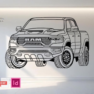 Może przedstawiać: Czarno-biały rysunek linii pickupa RAM TRX. Samochód ma duże opony terenowe, charakterystyczną osłonę chłodnicy z logo RAM i wlot powietrza na masce. Obraz zawiera tekst "CARWELL GRAPHICS" oraz ikony PDF, DXF i Id.