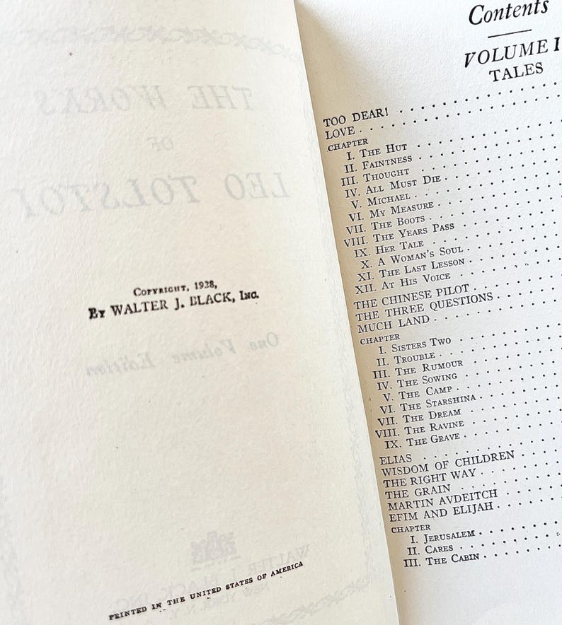 May include: A vintage book titled "Too Dear! Love" with a table of contents listing chapters for the book. The book is printed in black ink on white paper and has a copyright date of 1928.