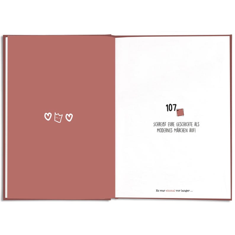 May include: Open book with a red-brown cover and white pages. The left page has three white heart illustrations. The right page has the number 107, a stamp illustration, and German text: SCHREIBT EURE GESCHICHTE ALS MODERNES M&Auml;RCHEN AUF!