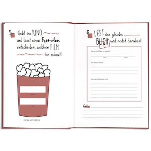 May include: Open journal with two facing pages. The left page features a popcorn bucket illustration with fill-in-the-blank prompts. The right page has book-related prompts. Text includes "Geht ins KINO" and "LEST das gleiche BUCH".