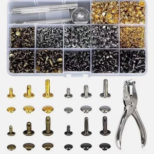 May include: A clear plastic organiser containing an assortment of metal rivets and tools. Rivets are in gold, silver, and black. A silver metal hole punch is also included. Suitable for leathercraft and DIY projects.