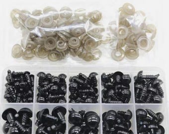 May include: A clear plastic organizer filled with various sizes of black plastic safety eyes and tan plastic backing washers for crafting. The eyes have different shapes and screw lengths. The washers are in a clear plastic bag.