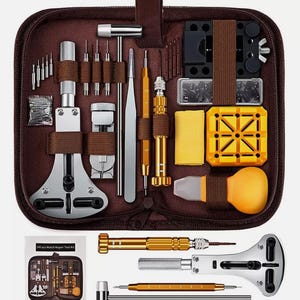 May include: A brown zipped case containing a 147-piece watch repair tool kit. The kit includes various tools such as screwdrivers, tweezers, and watch holders. The kit also includes a small instruction booklet.