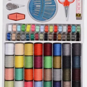 May include: A sewing kit containing a variety of tools and materials. The kit includes multi-coloured thread spools, needles, scissors, a tape measure, and other sewing accessories. The items are neatly arranged in a white box, perfect for sewing projects.