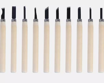 May include: A set of ten wood carving tools with various blade shapes. Each tool has a light-colored wooden handle and a dark, metal blade. The tools are arranged in a row against a plain background, showcasing their different cutting edges.