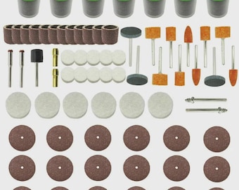 May include: A comprehensive rotary tool kit featuring a variety of accessories. The kit includes green-lidded containers, brown sanding drums, grinding stones, polishing wheels, and cutting discs. The tools are arranged neatly against a light background, showcasing their diverse shapes and sizes.