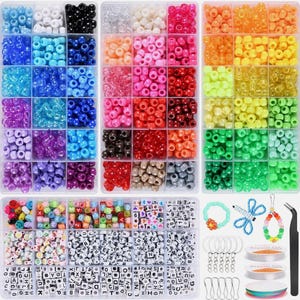 May include: A craft kit containing a variety of colourful beads in organised compartments. Includes round, letter, and number beads, plus jewellery-making supplies such as keychains, string, and tweezers. The beads are in shades of blue, pink, orange, green, and more.