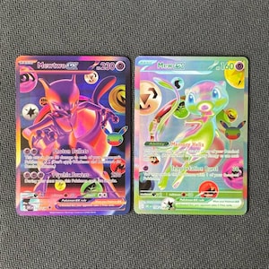 May include: Two Pokémon trading cards featuring Mewtwo ex with 230 HP and Mew ex with 160 HP. The Mewtwo card displays a purple and orange color scheme with Photon Bullets and Psychic Powers attacks. The Mew card features a holographic rainbow design.
