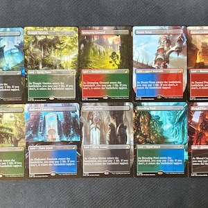 May include: A collection of ten Magic: The Gathering trading cards arranged in two rows. Each card features full-art illustrations of various landscapes, including Watery Grave, Temple Garden, Stomping Ground, Steam Vents, Sacred Foundry, Overgrown Tomb, Hallowed Fountain, Godless Shrine, Breeding Pool, and Blood Crypt.