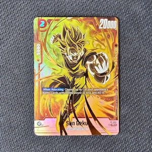 May include: A holographic Dragon Ball Super trading card featuring Son Goku in a dynamic fighting stance. The card displays a yellow and orange color palette, a power level of 20000, and text stating: When Attacking Choose up to 1 of your opponent's Battle Cards with 10000 power or less and KO it.