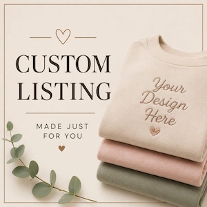 May include: A stack of three folded crewneck sweatshirts in beige, light pink, and sage green. The top beige sweatshirt features embroidered text that reads Your Design Here with a small heart icon. The background includes the text CUSTOM LISTING.