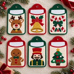 May include: Six rectangular fabric gift tags with embroidered holiday designs including a reindeer, a gold bell, candy canes, a gingerbread person, a nutcracker, and a Christmas tree, each featuring a white blank space for writing.