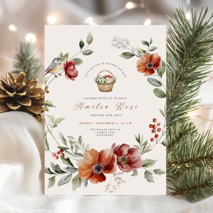 May include: A floral invitation with the text "Amelia Rose" and event details. The design features watercolor flowers in shades of red and orange, with green foliage and a small bird. The invitation is surrounded by a wreath of flowers and greenery.