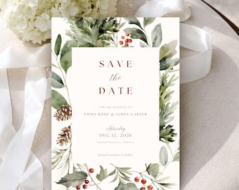 May include: A rectangular Save the Date card featuring a white center with dark red text reading Save the Date, Emma Rose & James Carter, and Dec 12, 2026. The border is decorated with watercolor illustrations of green pine branches, brown pinecones, and red berries.