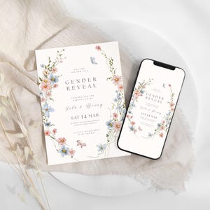 May include: A gender reveal invitation card and a smartphone displaying the same design. The white card features a watercolor floral wreath with pink and blue flowers, butterflies, and text reading Gender Reveal, Lila & Henry, Sat 14 Mar.