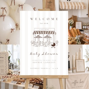 Peut inclure: Scène de baby shower avec une pancarte « Bienvenue à notre Baby Shower Café Bébé ». La pancarte est sur un chevalet, entourée de ballons, de pâtisseries et d'un bar à café. L'événement célèbre Sophie Langley.