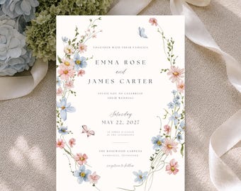 May include: A rectangular wedding invitation card featuring a watercolor floral border of pink and blue flowers with two small butterflies. The text reads: Together with their families, Emma Rose and James Carter, invite you to celebrate their wedding, Saturday, May 22, 2027, at three o'clock in the afternoon, The Rosewood Gardens, Nashville, Tennessee, reception to follow.