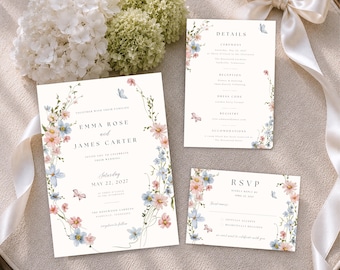 May include: A wedding invitation suite featuring a main invitation, a details card, and an RSVP card. Each white card is decorated with watercolor illustrations of pink and blue flowers, green vines, and small butterflies, with black serif text.