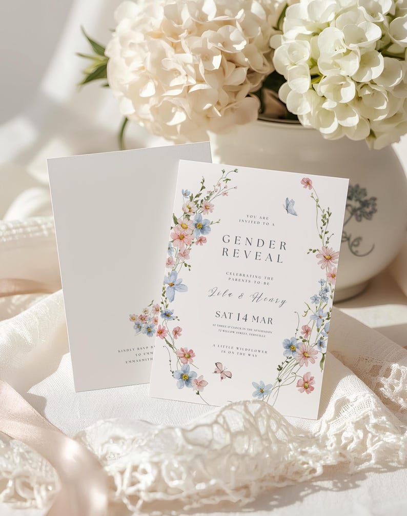May include: A white gender reveal invitation card featuring a floral wreath of pink and blue wildflowers, green stems, and small butterflies. The text reads: You are invited to a Gender Reveal, celebrating the parents to be, Jile & Henry, Sat 14 Mar.