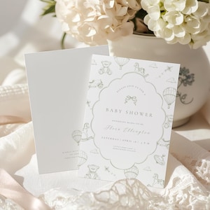 May include: Baby shower invitation in soft green and white. The design includes a scalloped border with toy and hot air balloon illustrations. The text reads "Baby Shower" and includes the honoree's name and event details.