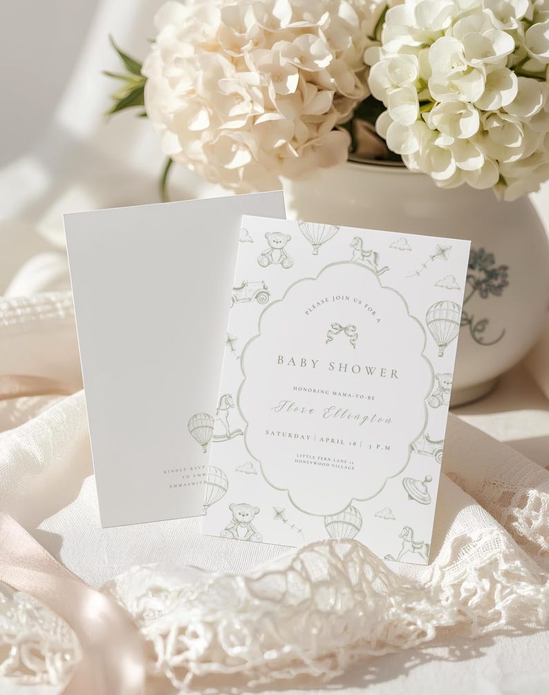May include: Baby shower invitation in soft green and white. The design includes a scalloped border with toy and hot air balloon illustrations. The text reads "Baby Shower" and includes the honoree's name and event details.