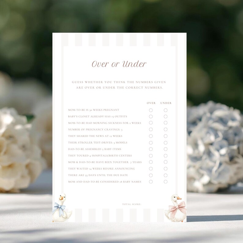 May include: A baby shower game card with the text "Over or Under" in a script font. The card has a striped background and features a list of questions with spaces to check "Over" or "Under". Two cartoon geese with bows are at the bottom.