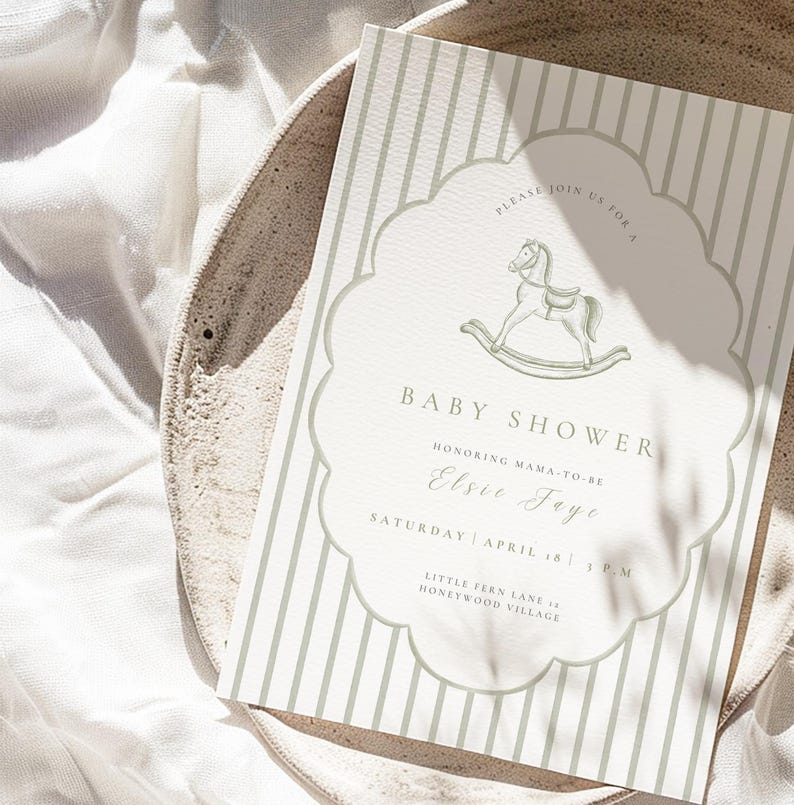 May include: Baby shower invitation with a rocking horse illustration. The invitation has a scalloped border and vertical stripes in a soft green hue. Text includes "Baby Shower" and event details for Elsie Jaye.