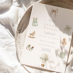May include: A gender reveal invitation with watercolor illustrations of baby items. The invitation includes text that reads "Gender Reveal" and "Daisy & Theo". The design features a rocking horse, baby clothes, and a hot air balloon.