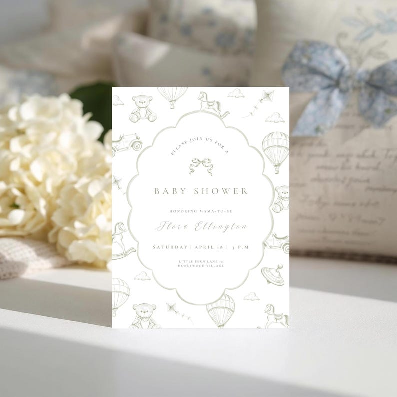 May include: A baby shower invitation with a scalloped edge, decorated with drawings of hot air balloons, teddy bears, and toy cars. The text reads "Baby Shower" and includes the honoree's name and event details. The invitation is in soft green and white.