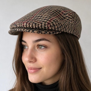 May include: A flat cap featuring a multi-colored houndstooth and plaid pattern in shades of brown, tan, black, and dark red. The cap has a structured, rounded crown and a short, stiff brim extending from the front, crafted from a woven fabric.